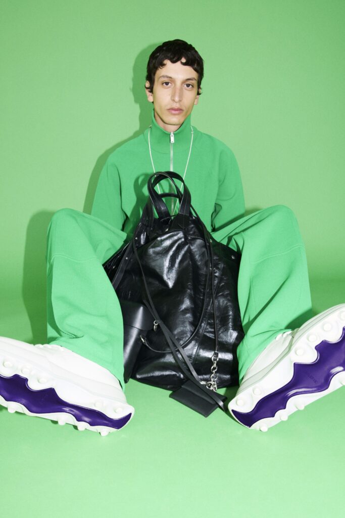 A relaxed green cotton jacket with long sleeves and a zippered front.