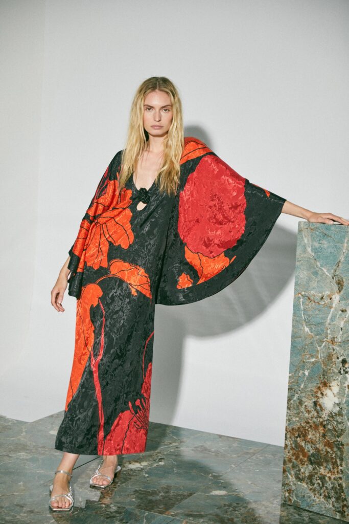 A relaxed black and red silk dress with a V-neckline and flared silhouette.