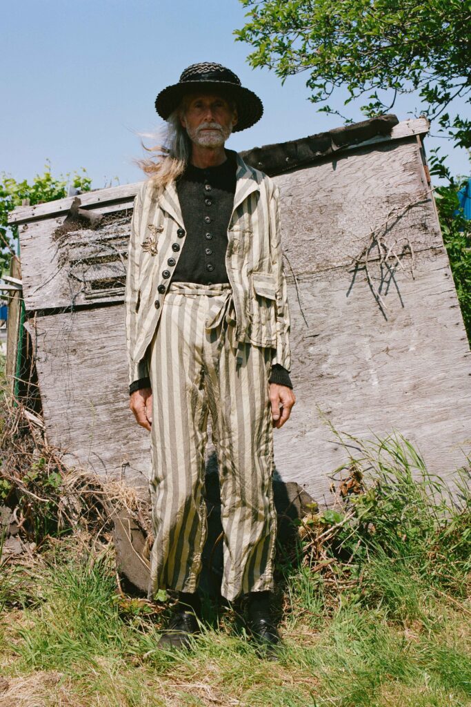 A relaxed beige striped jacket with long sleeves paired with matching striped pants.