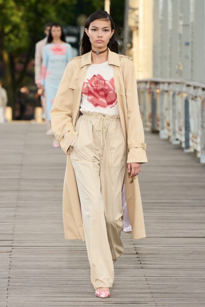 A relaxed beige cotton trench coat paired with matching relaxed pants, featuring a collared design.