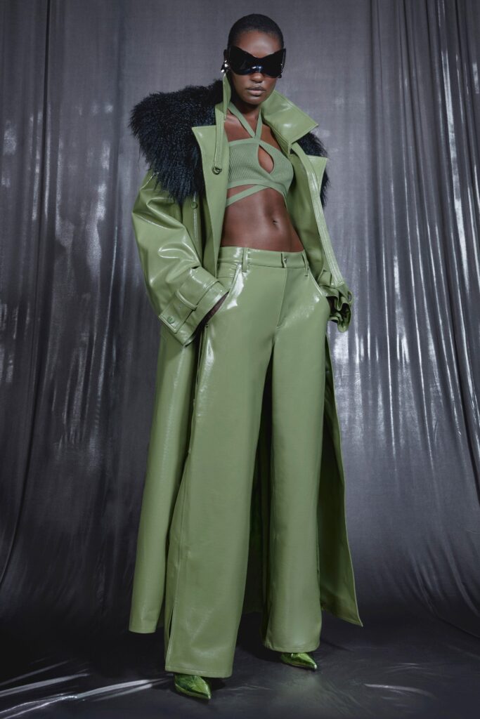 A relaxed green leather coat paired with wide-leg pants, featuring a collared design.