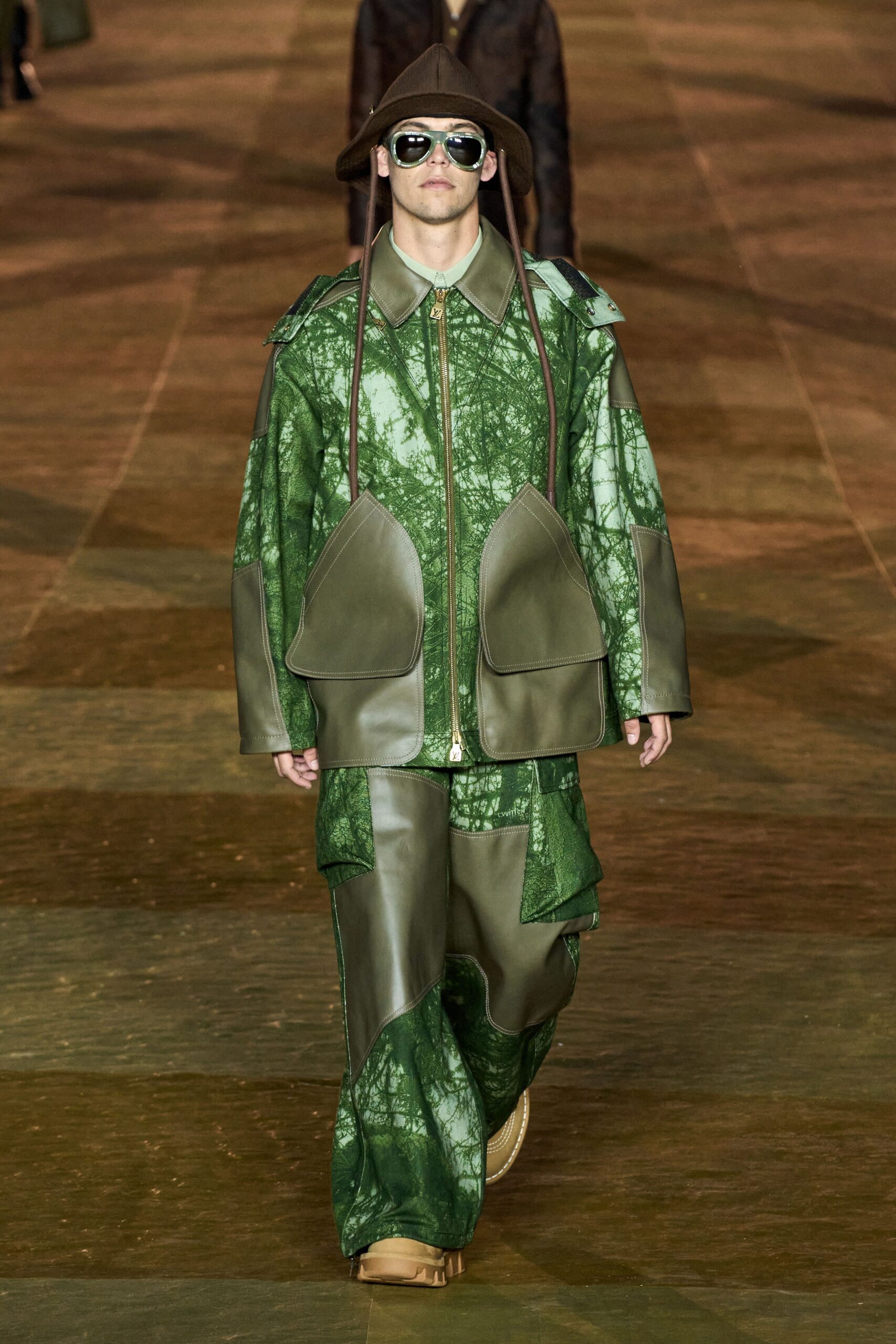 A relaxed green leather jacket with long sleeves and matching pants featuring a layered design.