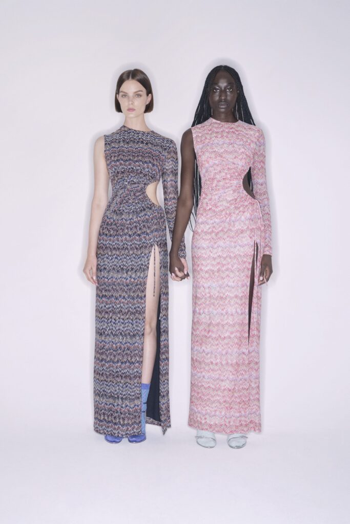 Two fitted dresses in pink and blue with high necklines and asymmetric slits.