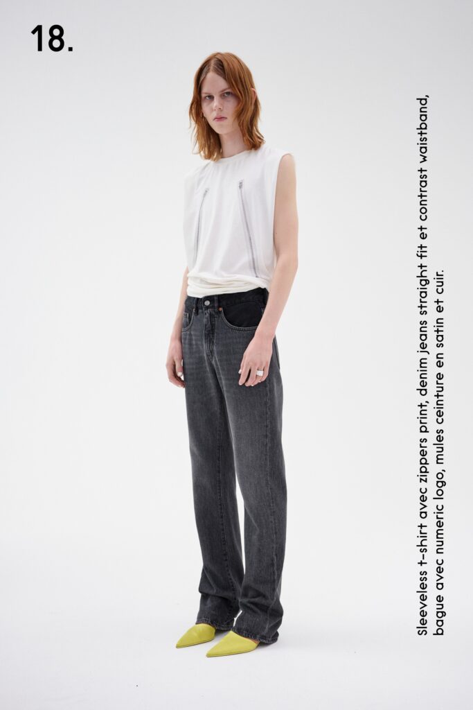 A relaxed white sleeveless top paired with straight-leg gray denim pants.
