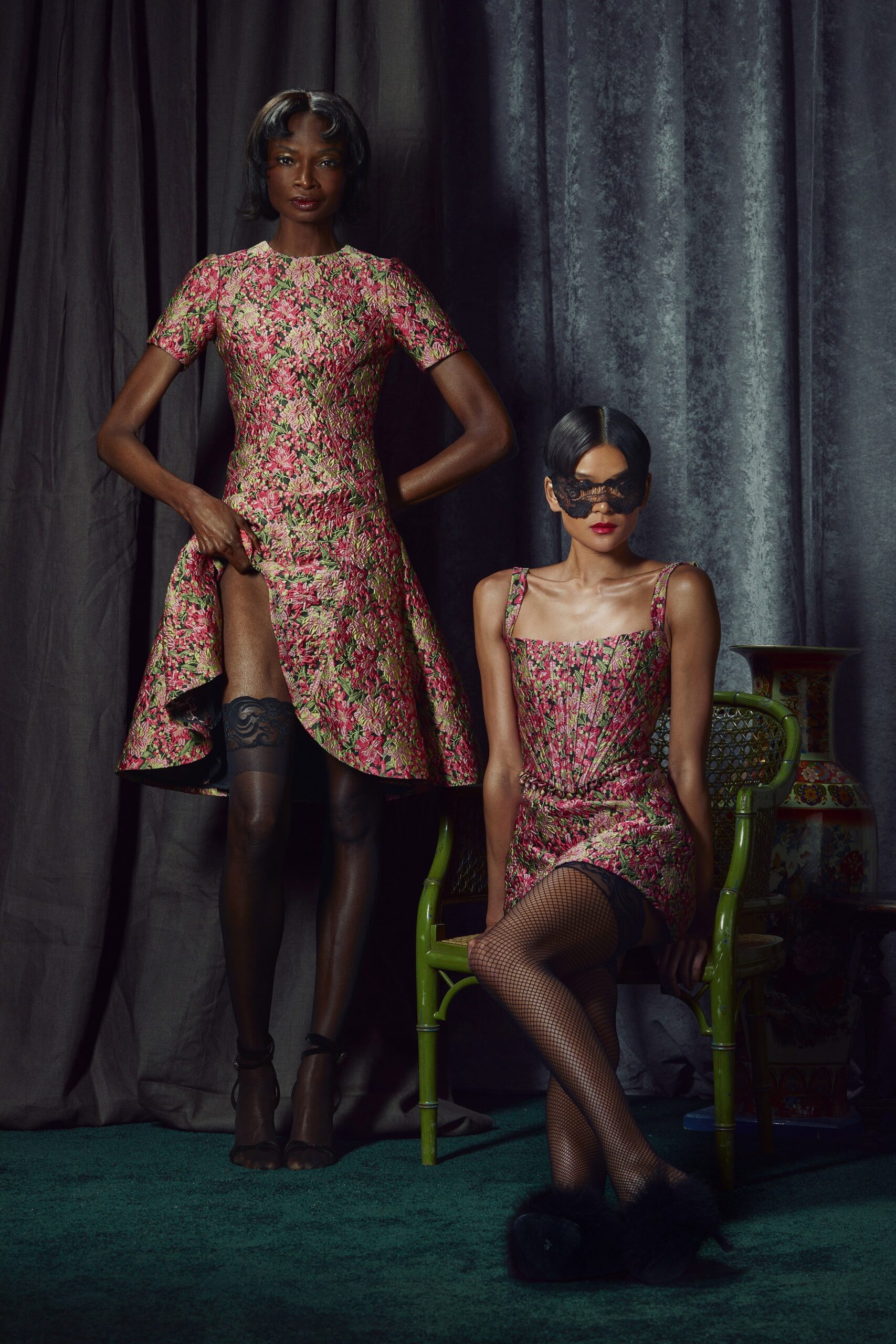 A fitted pink dress with a V-neckline and flared silhouette.