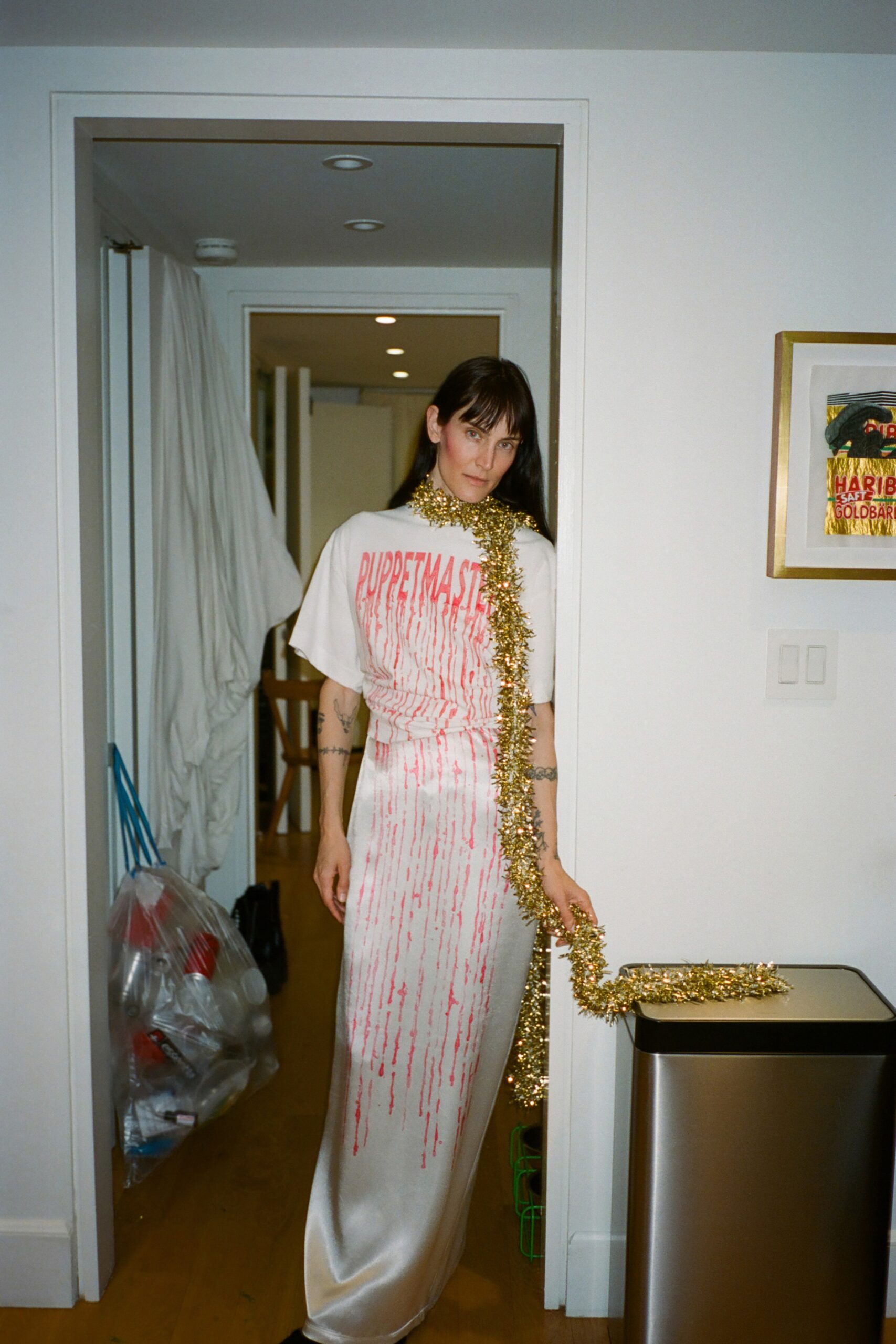 A fitted white dress with short sleeves, high neckline, and printed design details.