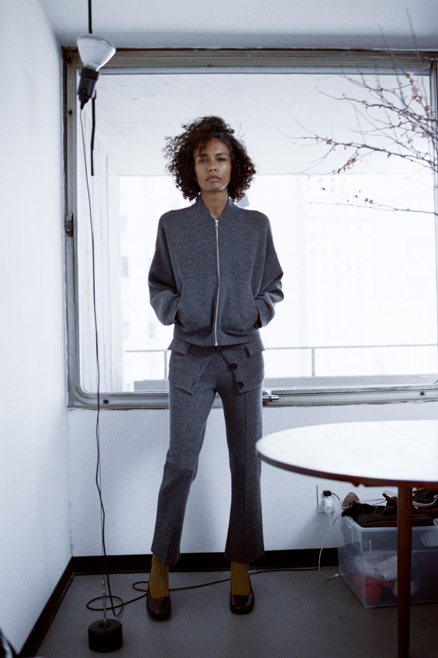A relaxed gray wool jacket with a zippered front paired with matching pants.