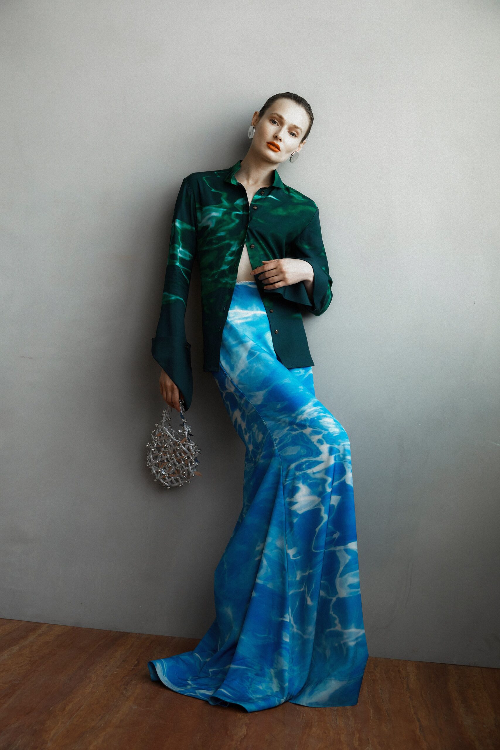 A fitted green silk collared top paired with a printed blue maxi skirt.