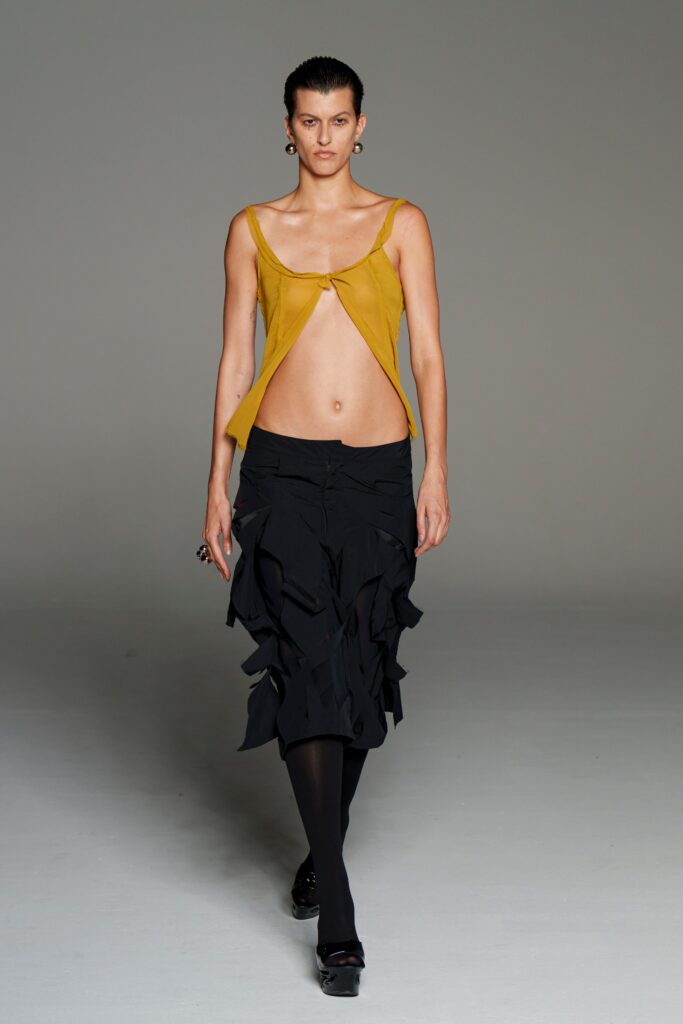 fitted yellow top and black ruffled skirt
