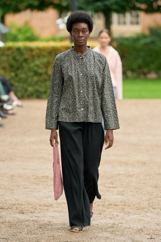 A relaxed fit multicolor printed jacket paired with black pants, featuring a collared neckline and long sleeves.