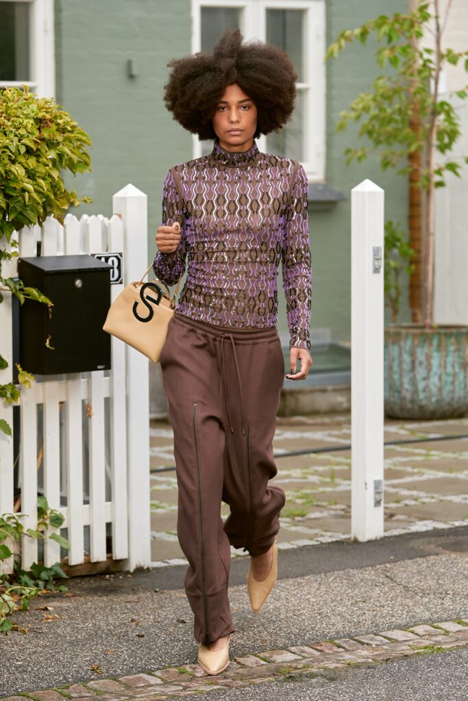 A relaxed brown printed long-sleeve top paired with relaxed-fit pants.