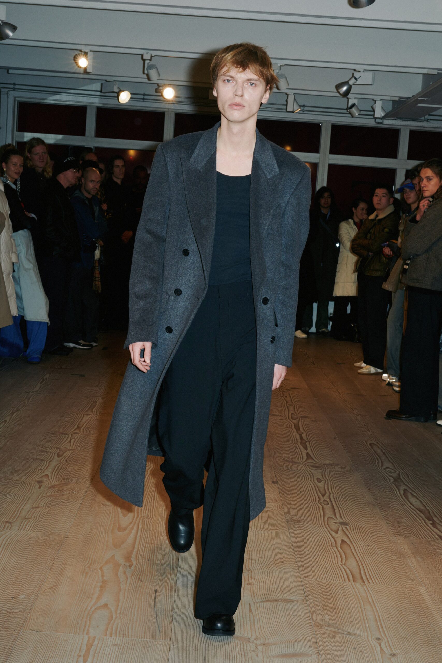gray wool tailored coat with black top and pants