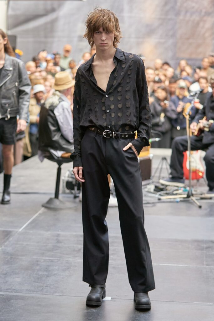 A relaxed black cotton shirt with a collar and long sleeves paired with matching black pants.