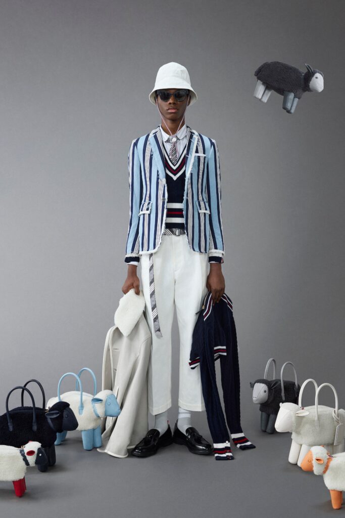 A fitted blue striped jacket with long sleeves and white pants, featuring a collared design.