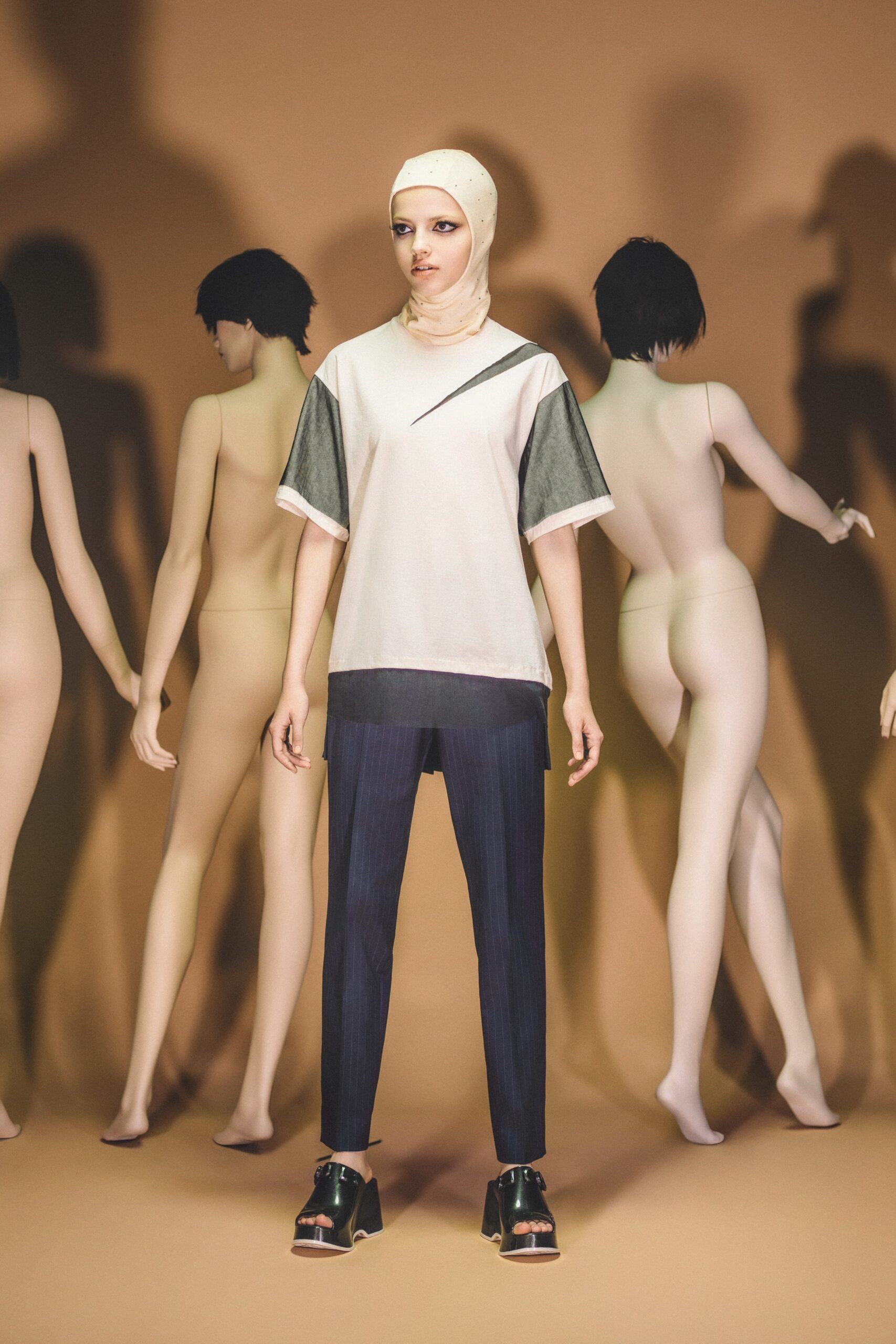 A relaxed white cotton top with short sleeves and blue striped pants.