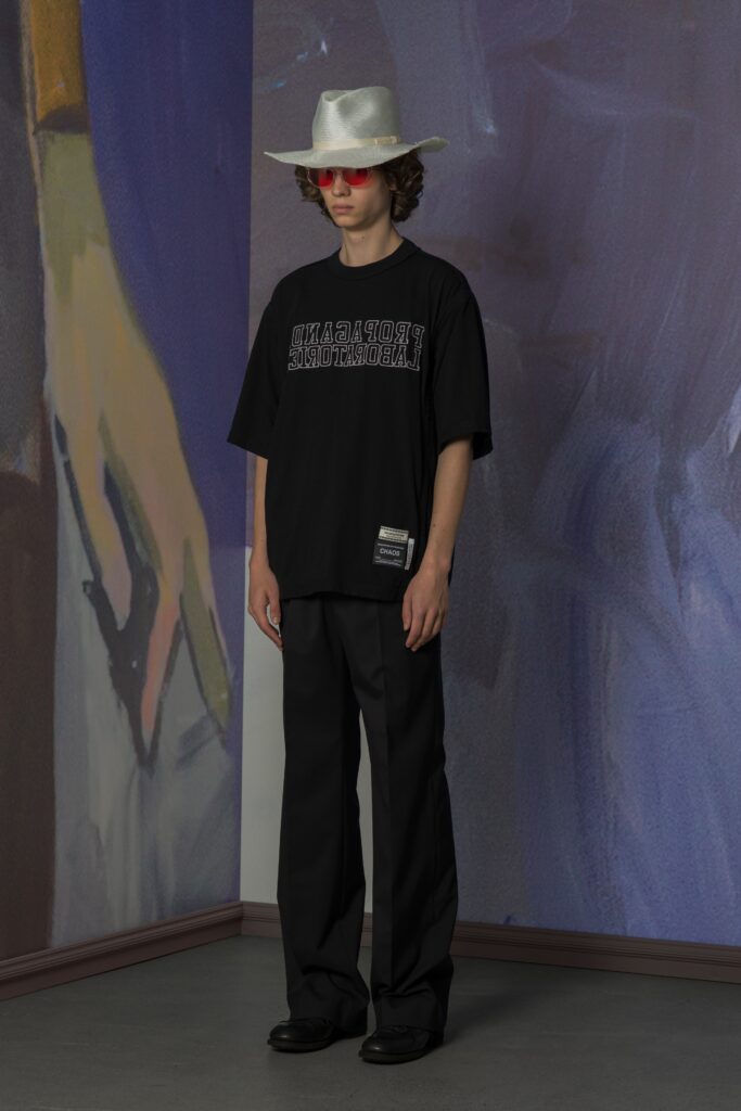 A relaxed black t-shirt with a printed design paired with loose-fitting pants.