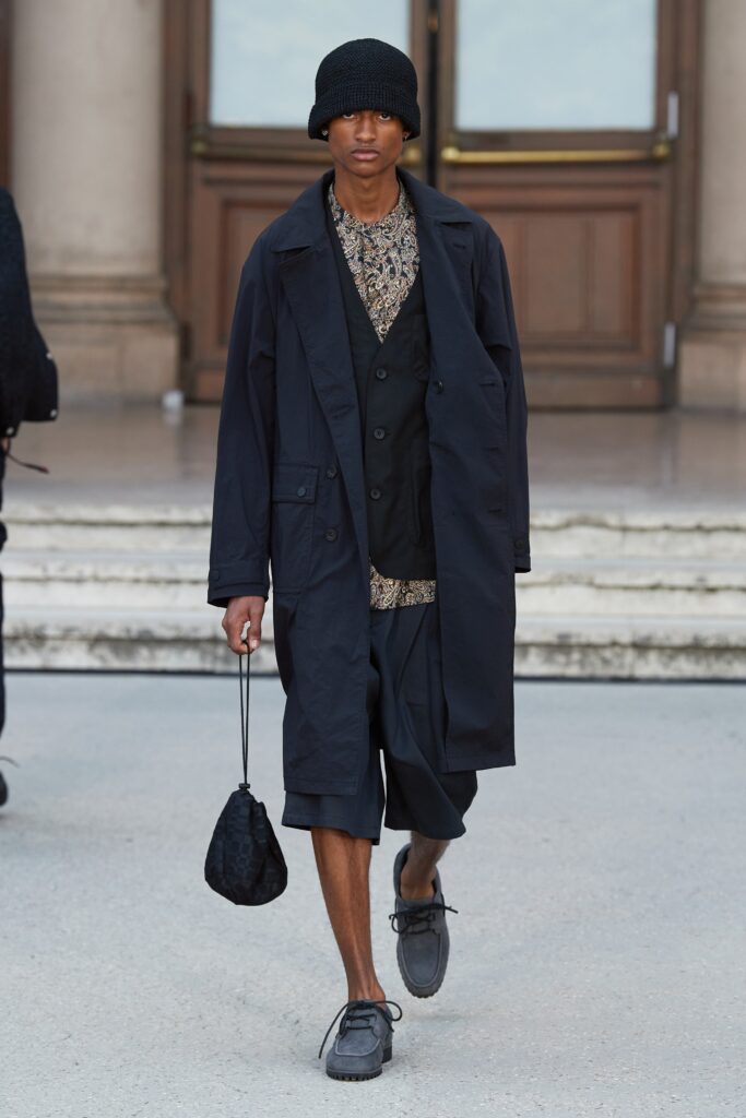 A relaxed black coat layered over a vest, featuring a collared design.