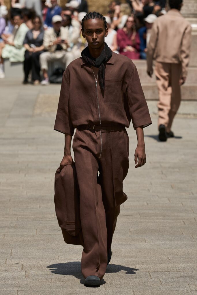 A relaxed brown cotton jacket with long sleeves and wide-leg pants, featuring a zippered detail.