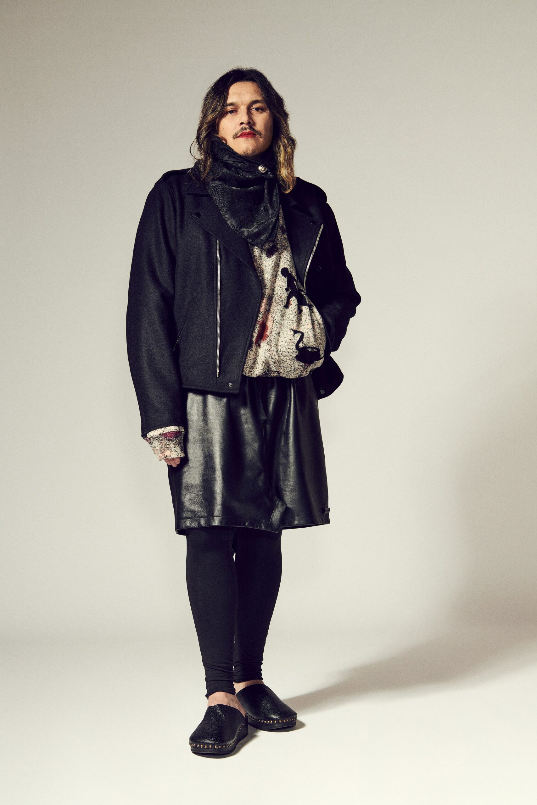 black jacket gray sweater leather skirt