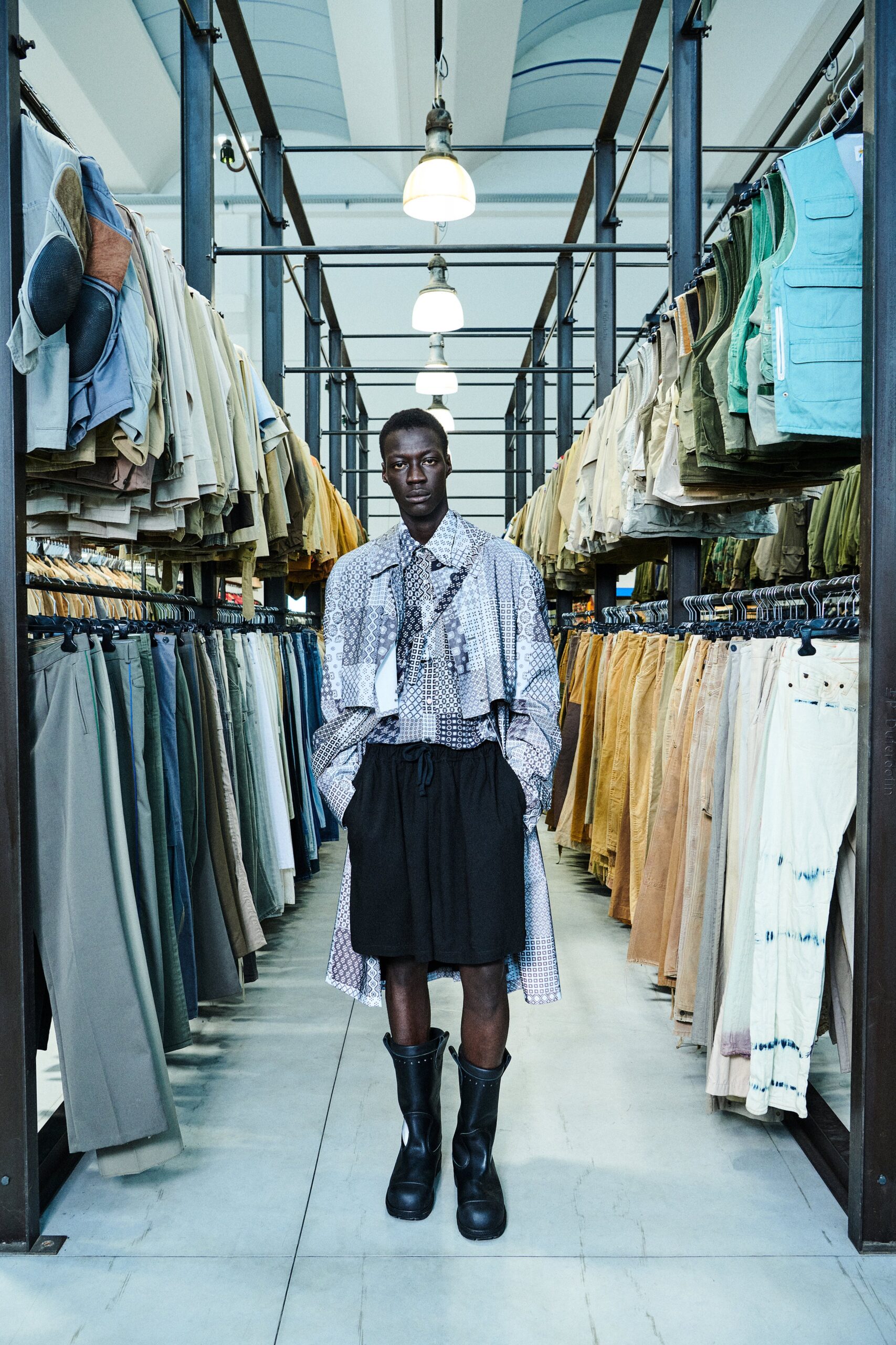 A relaxed multicolor dress with a black skirt, featuring long sleeves and an asymmetric layered design.