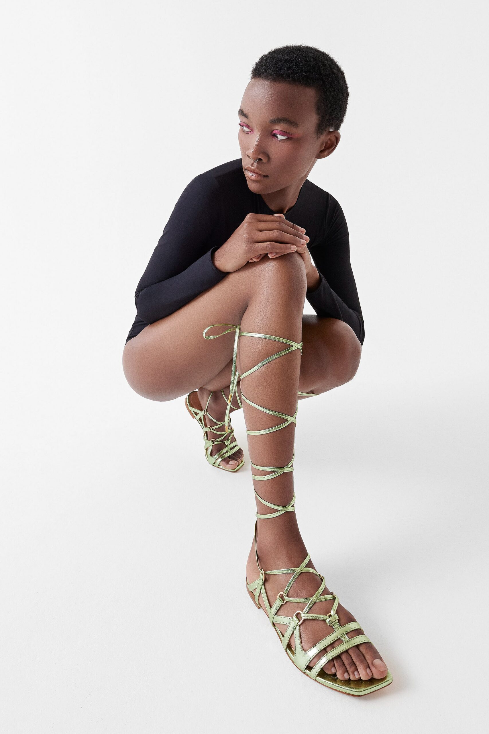 black fitted bodysuit with green shoes