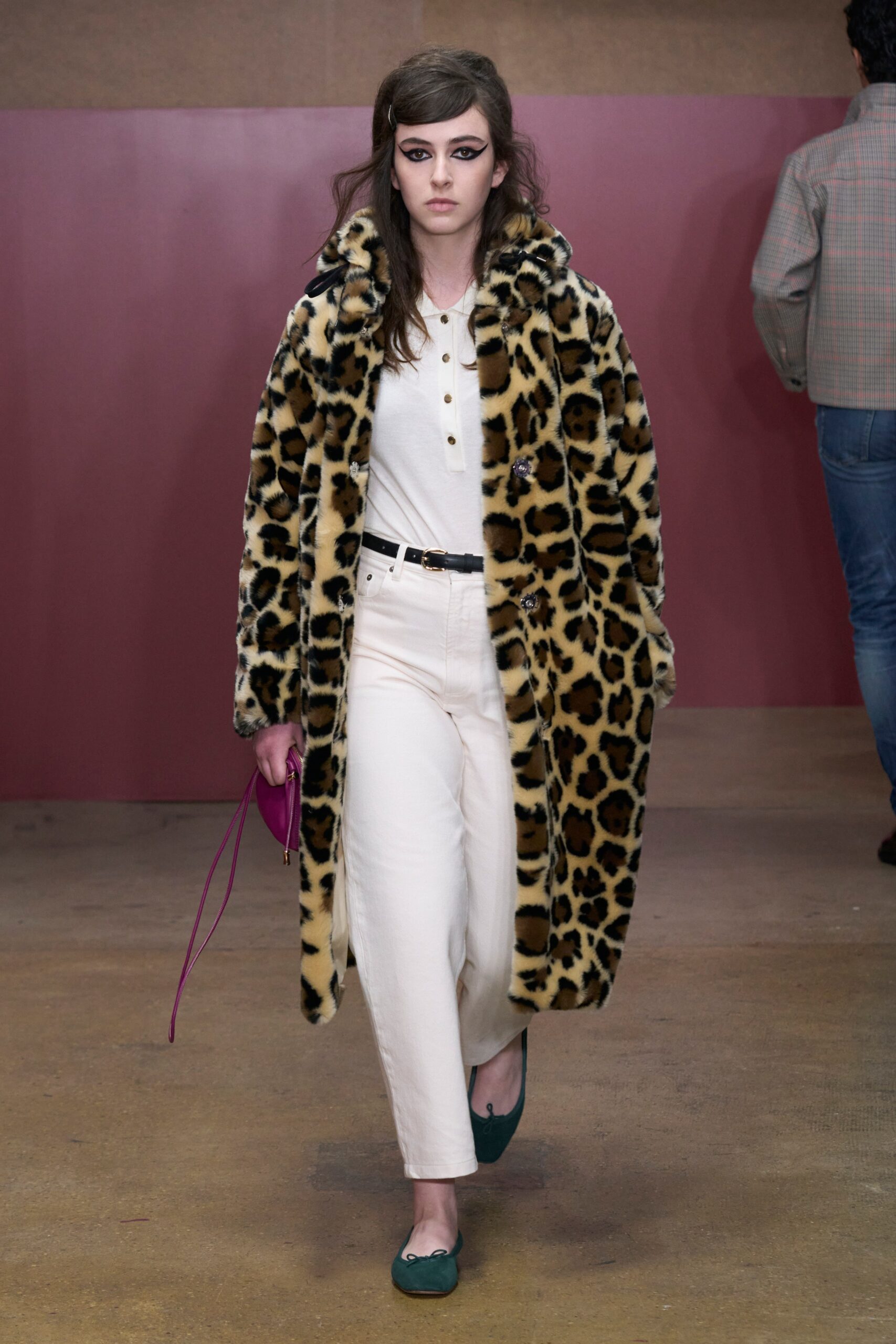 A relaxed beige faux-fur coat with an animal-print design paired with straight-leg cotton pants.