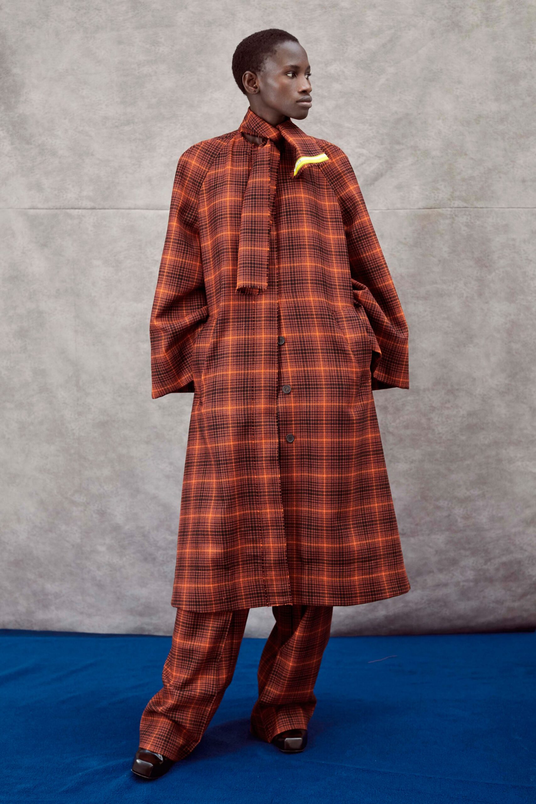 checked orange and brown coat and pants