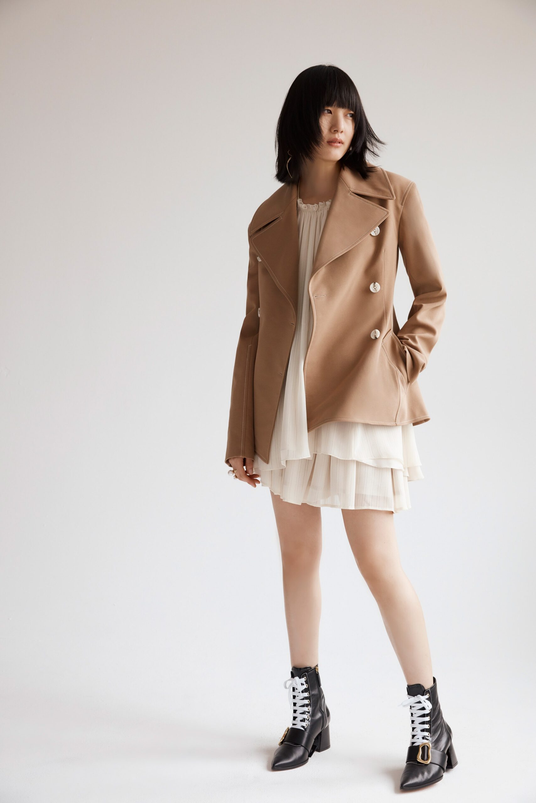 beige leather jacket white pleated dress