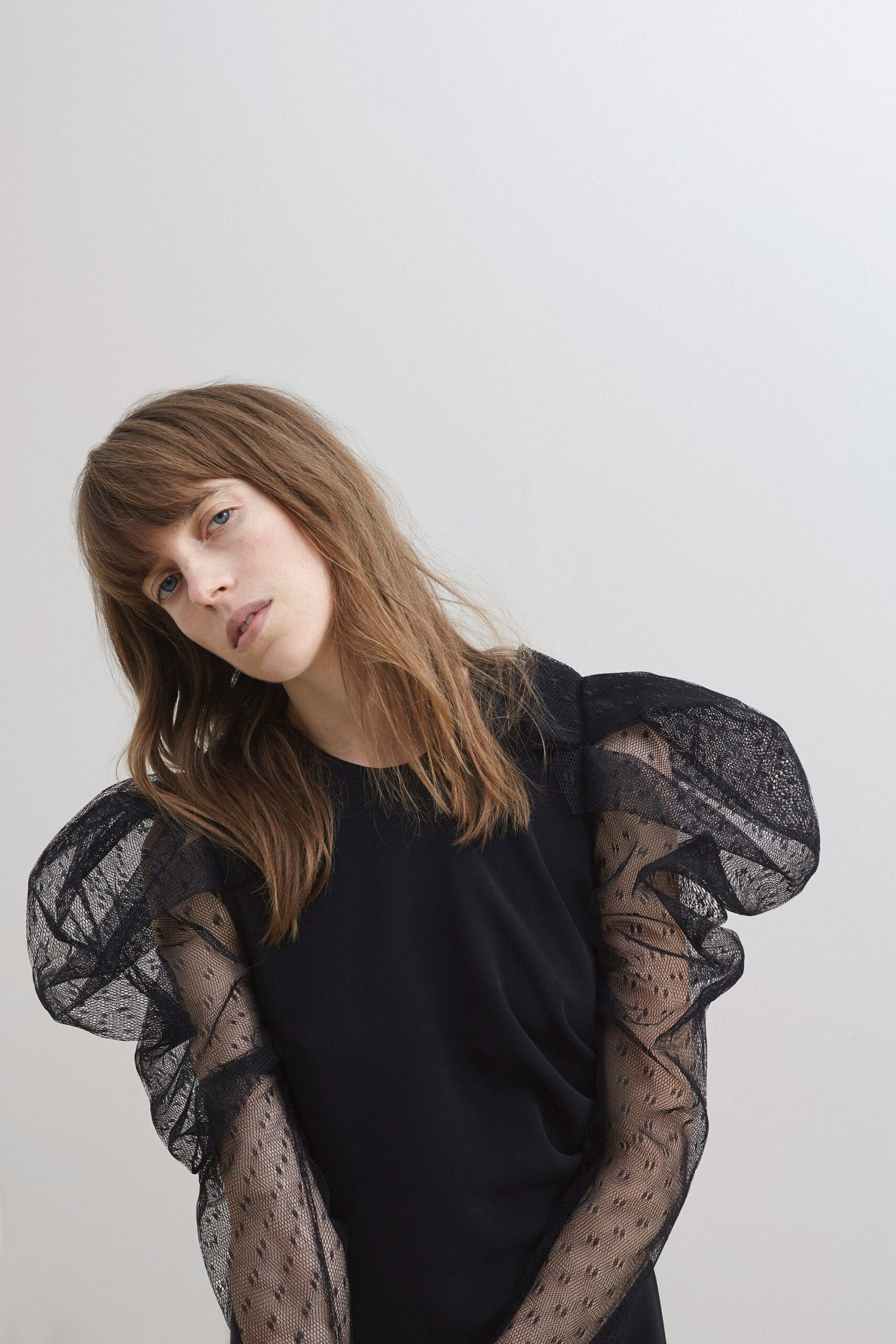 black fitted dress with ruffled sleeves
