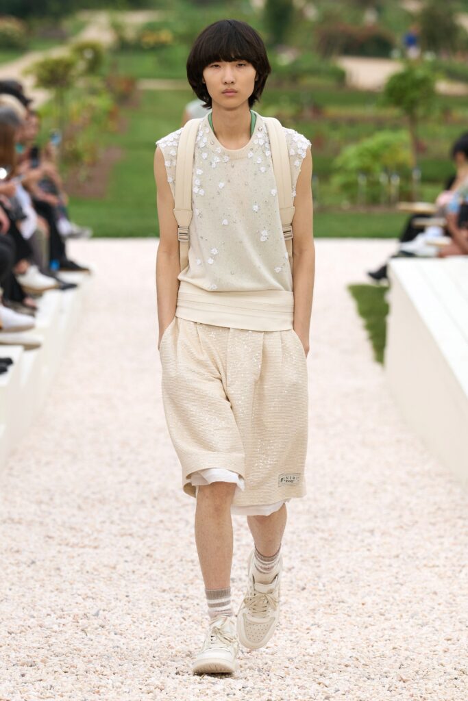 A relaxed beige sleeveless top with embroidery paired with matching shorts.