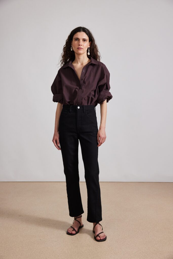 A relaxed brown long-sleeve collared shirt paired with straight-leg black pants.