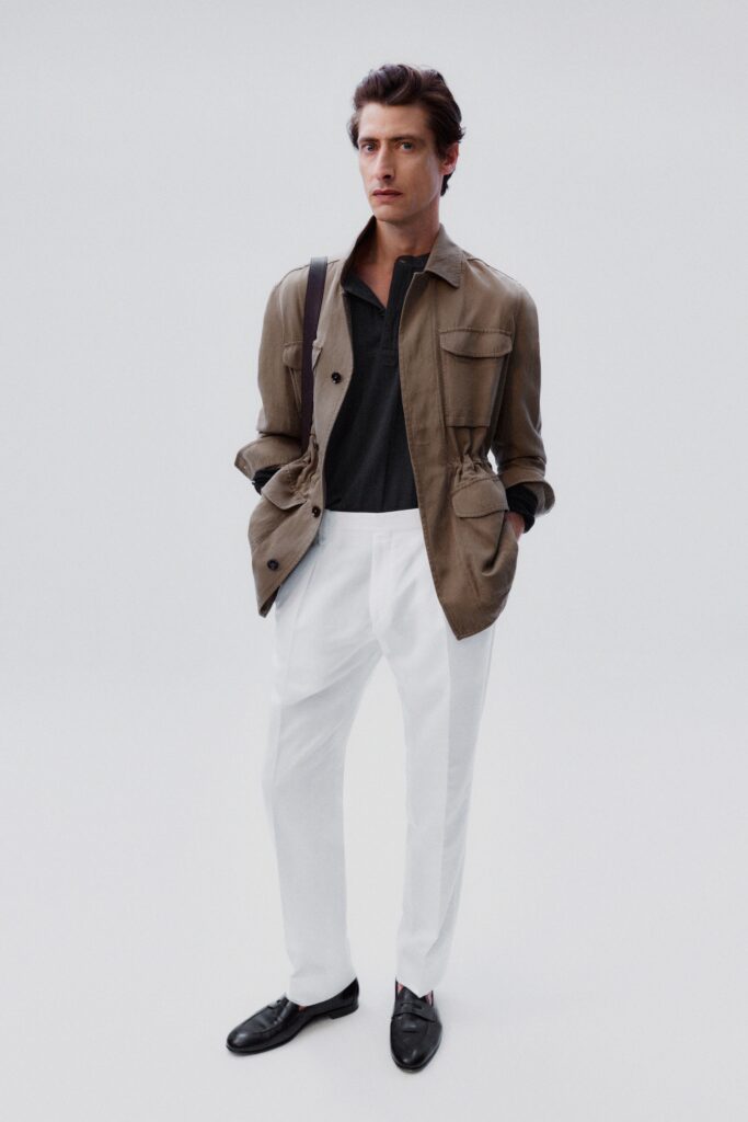 A tailored beige cotton jacket with long sleeves paired with straight-leg white pants.