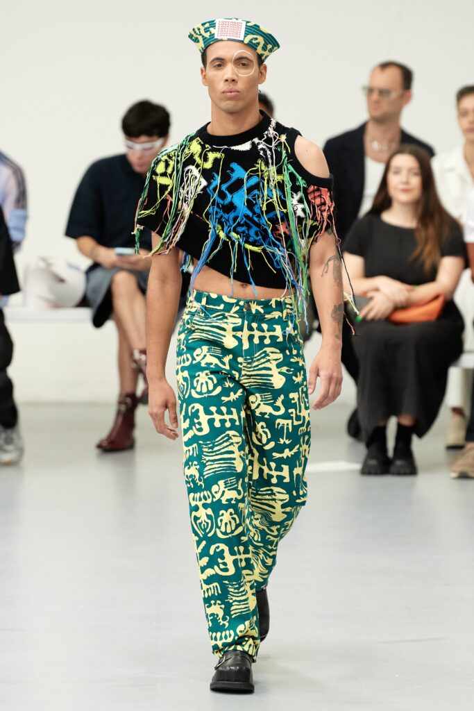 A fitted green printed top with short sleeves and cutouts, paired with matching pants.
