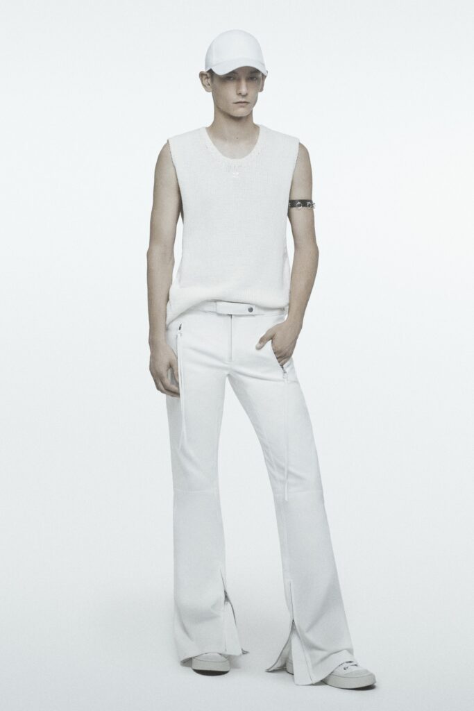 A fitted white sleeveless top paired with flared white pants for a modern look.