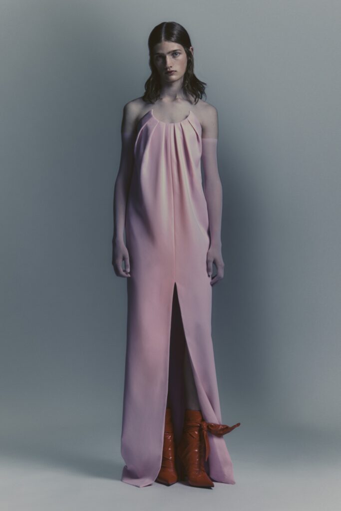A relaxed pink silk sleeveless dress featuring a V-neckline and a front slit.