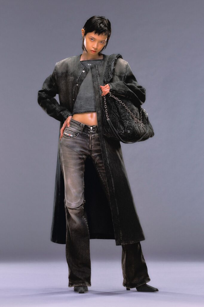 A fitted black denim coat with long sleeves and collared design paired with straight-leg pants.