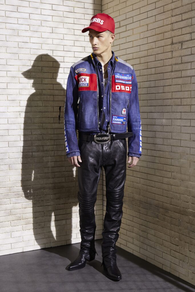 A fitted blue denim jacket with long sleeves paired with black leather pants.