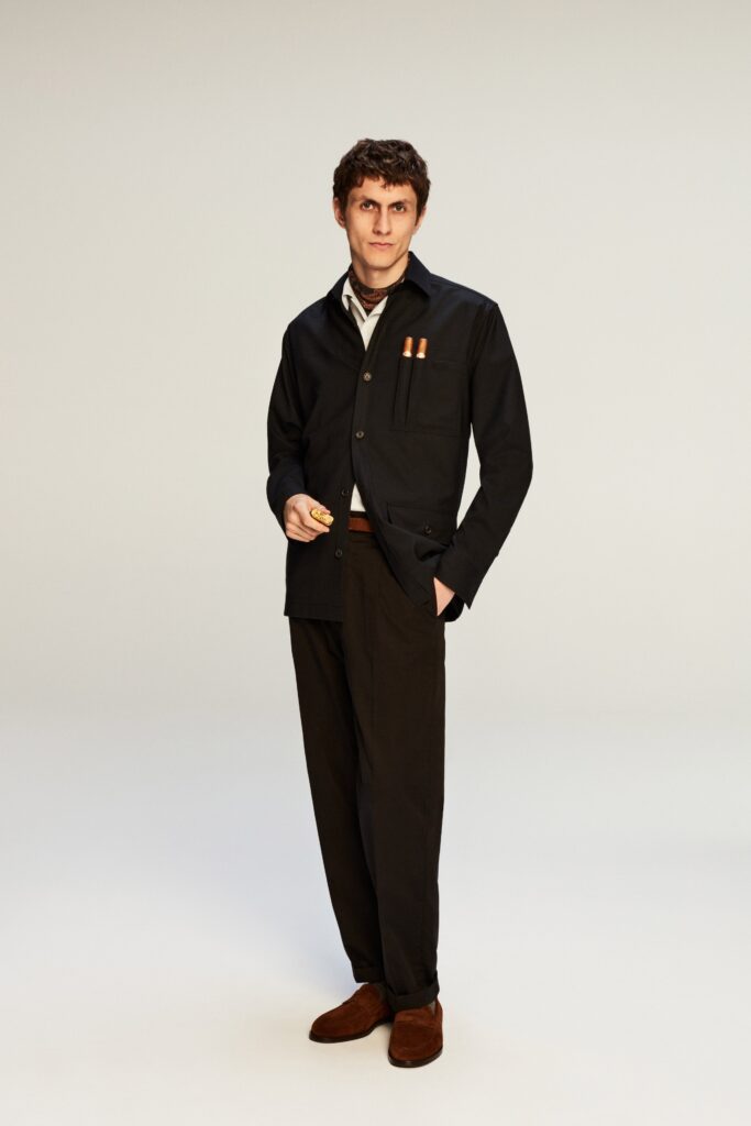 A relaxed black cotton jacket with long sleeves and collared design paired with matching pants.