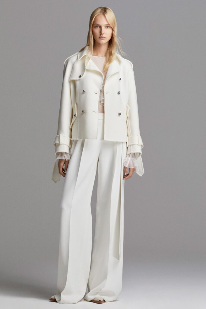 A relaxed white cotton jacket with long sleeves and wide-leg pants.