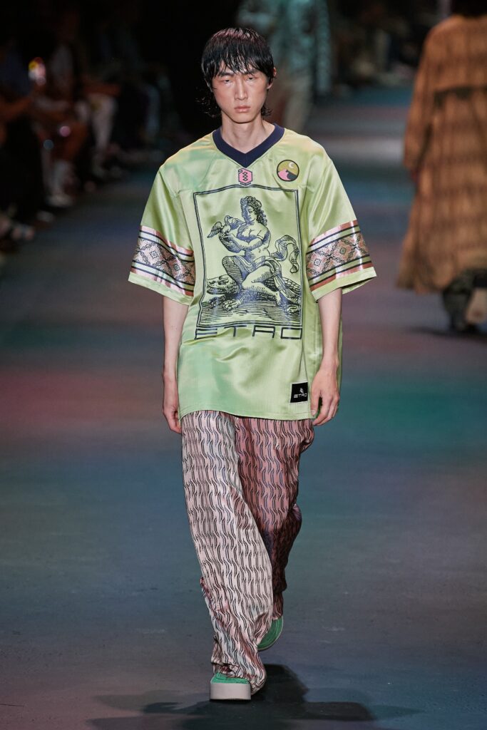 A relaxed green printed shirt with short sleeves paired with wide-leg patterned pants.
