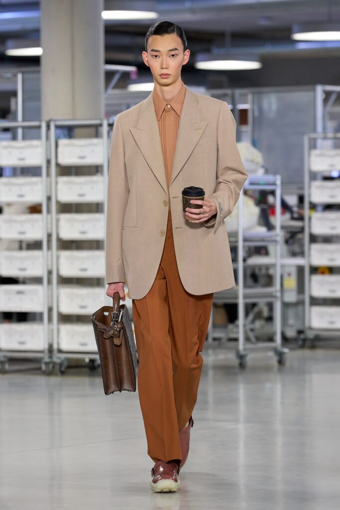 A tailored beige blazer paired with straight-leg brown pants, creating a sophisticated look.