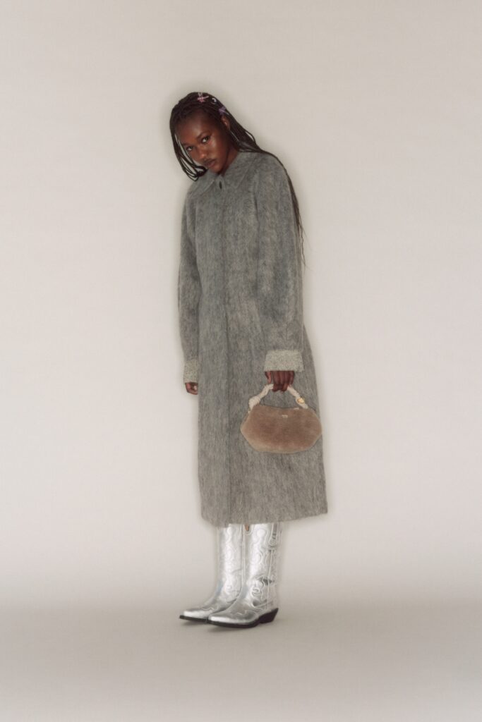A relaxed gray wool coat with long sleeves and a collared design.
