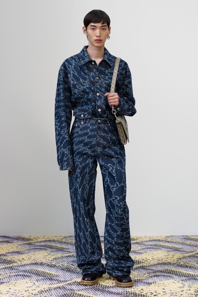 A relaxed fit blue denim jacket with long sleeves and collared design, paired with matching printed pants.