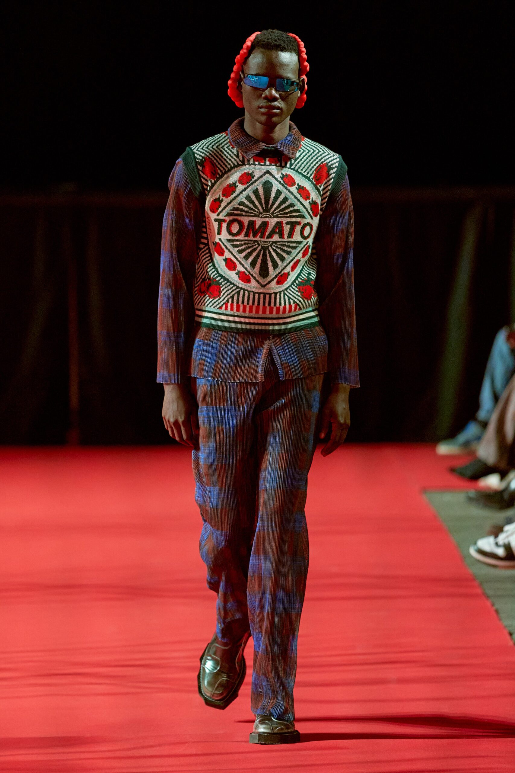 A fitted red and blue printed long-sleeve sweater paired with matching pants.
