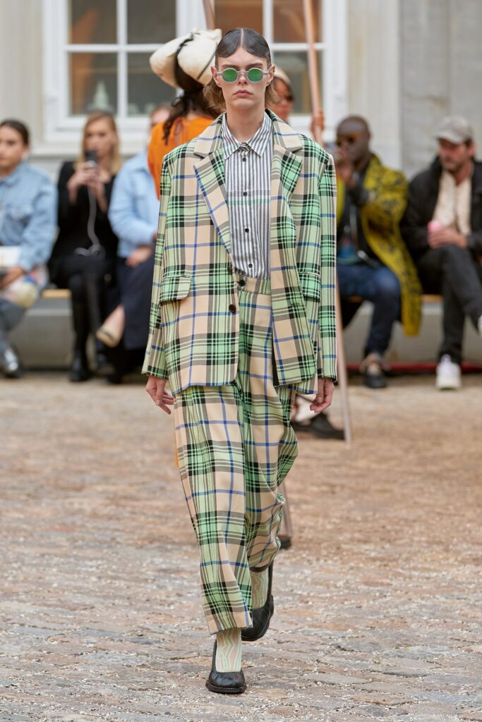 A relaxed fit checked suit in green and beige with a long-sleeve collared shirt.