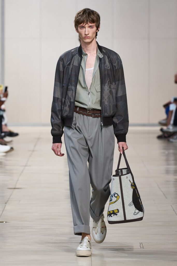 A relaxed gray cotton jacket with long sleeves and collared neckline paired with wide-leg pants.