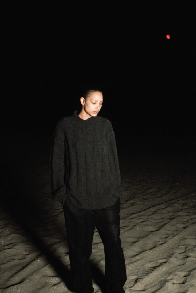 A relaxed black long-sleeve top paired with straight-leg pants for a casual look.