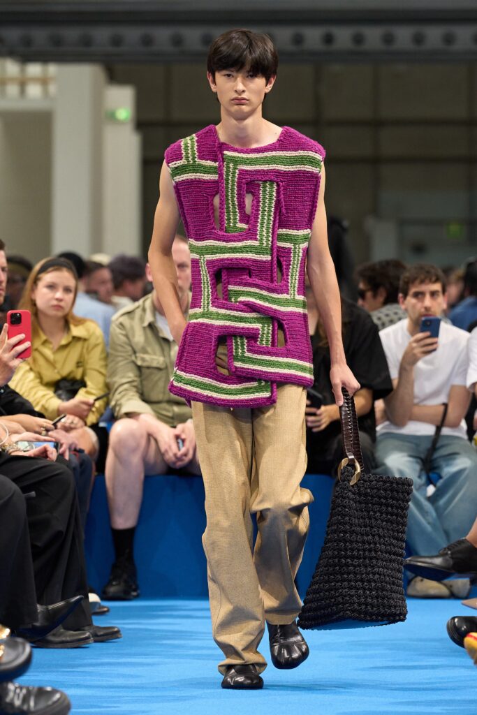 A relaxed fit purple printed sleeveless top paired with beige pants, showcasing a unique design.