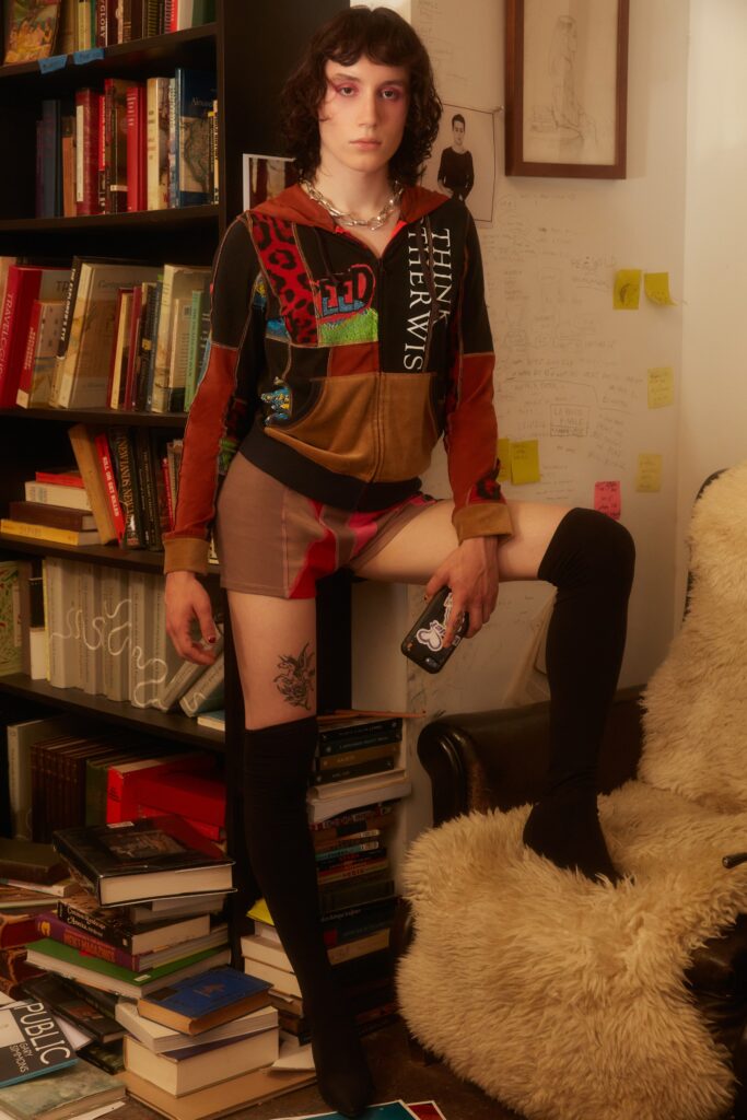 A fitted multicolor top with long sleeves and a collared neckline paired with stylish shorts.