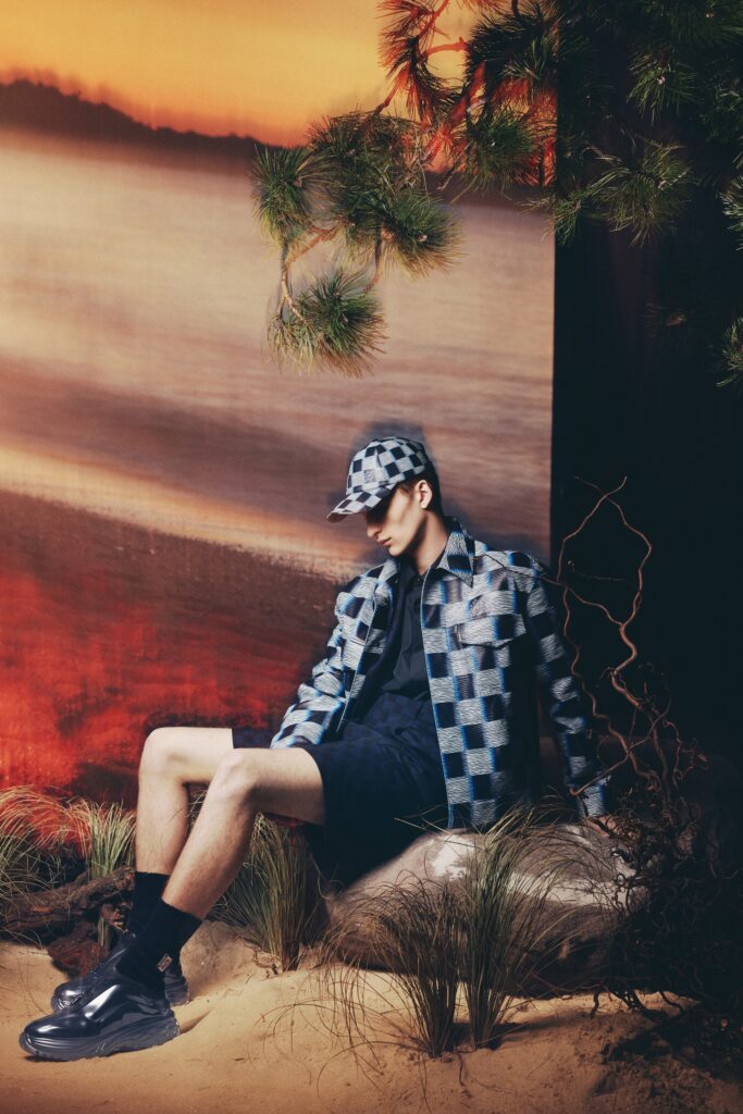 A relaxed blue checked jacket paired with black shorts, perfect for a casual summer look.